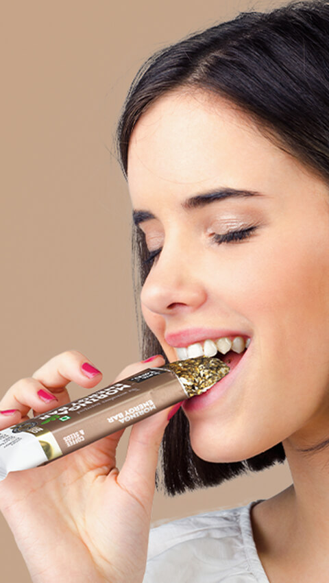 women eating energy bar amp